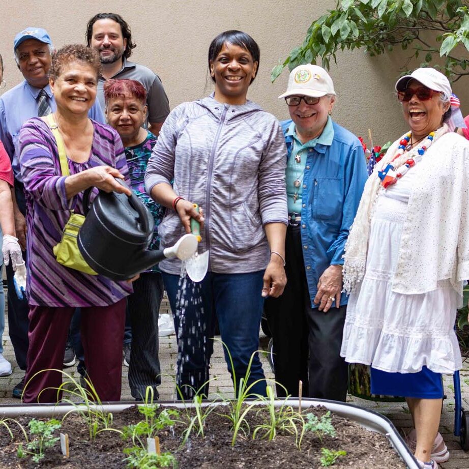 Group of Encore members working in the garden