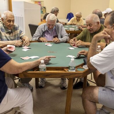 Older adults playing cards at Encore Community Center